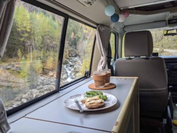breakfast in rented campervan by a river